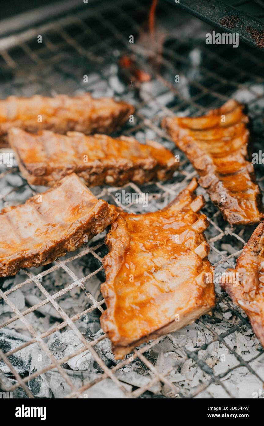 Short Rib Full Rack Cooked A rack of ribs is being cooked on a grill. The ribs are brown and ...