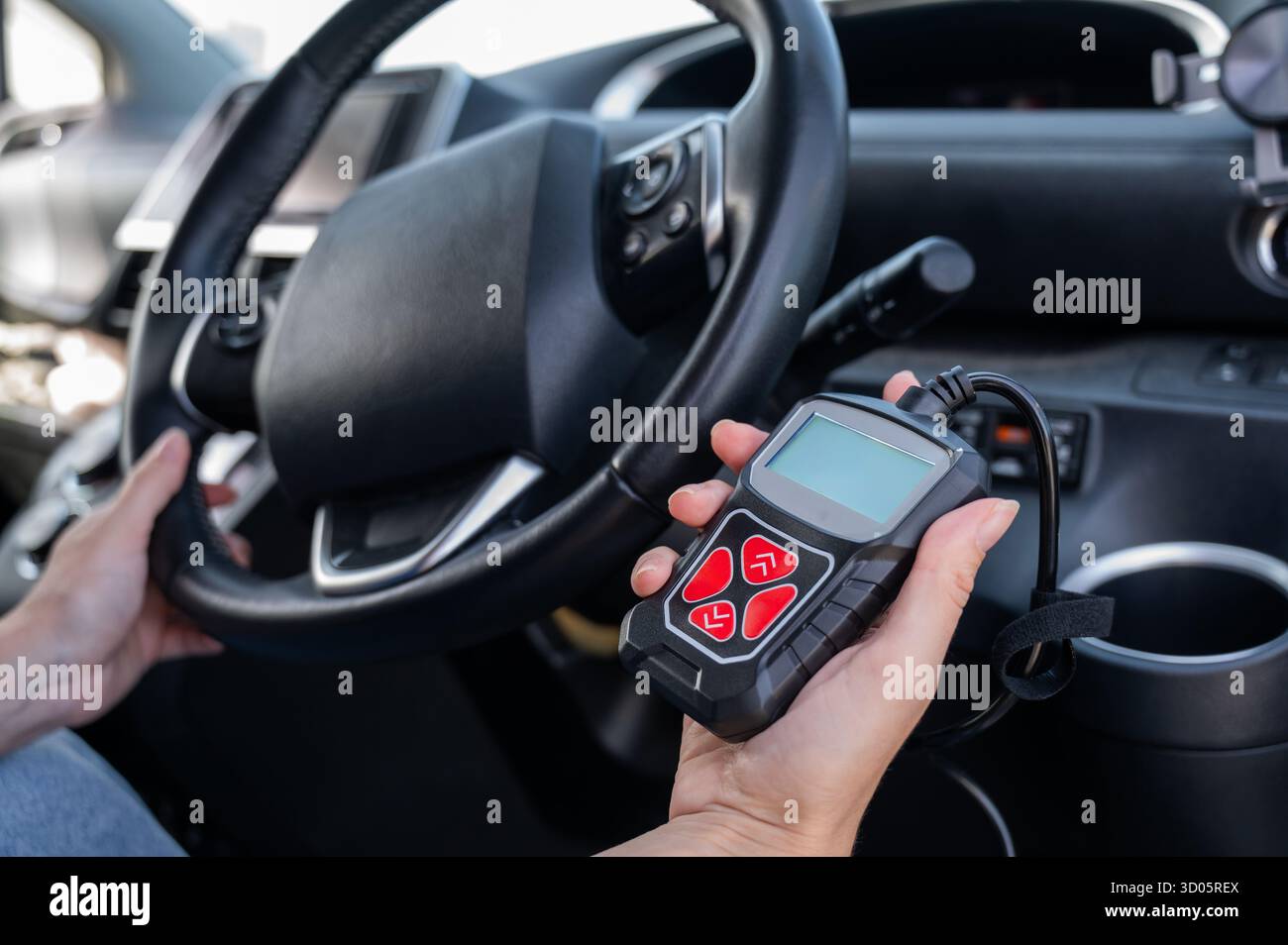 Woman using OBD2 diagnostic scanner.  Stock Photo