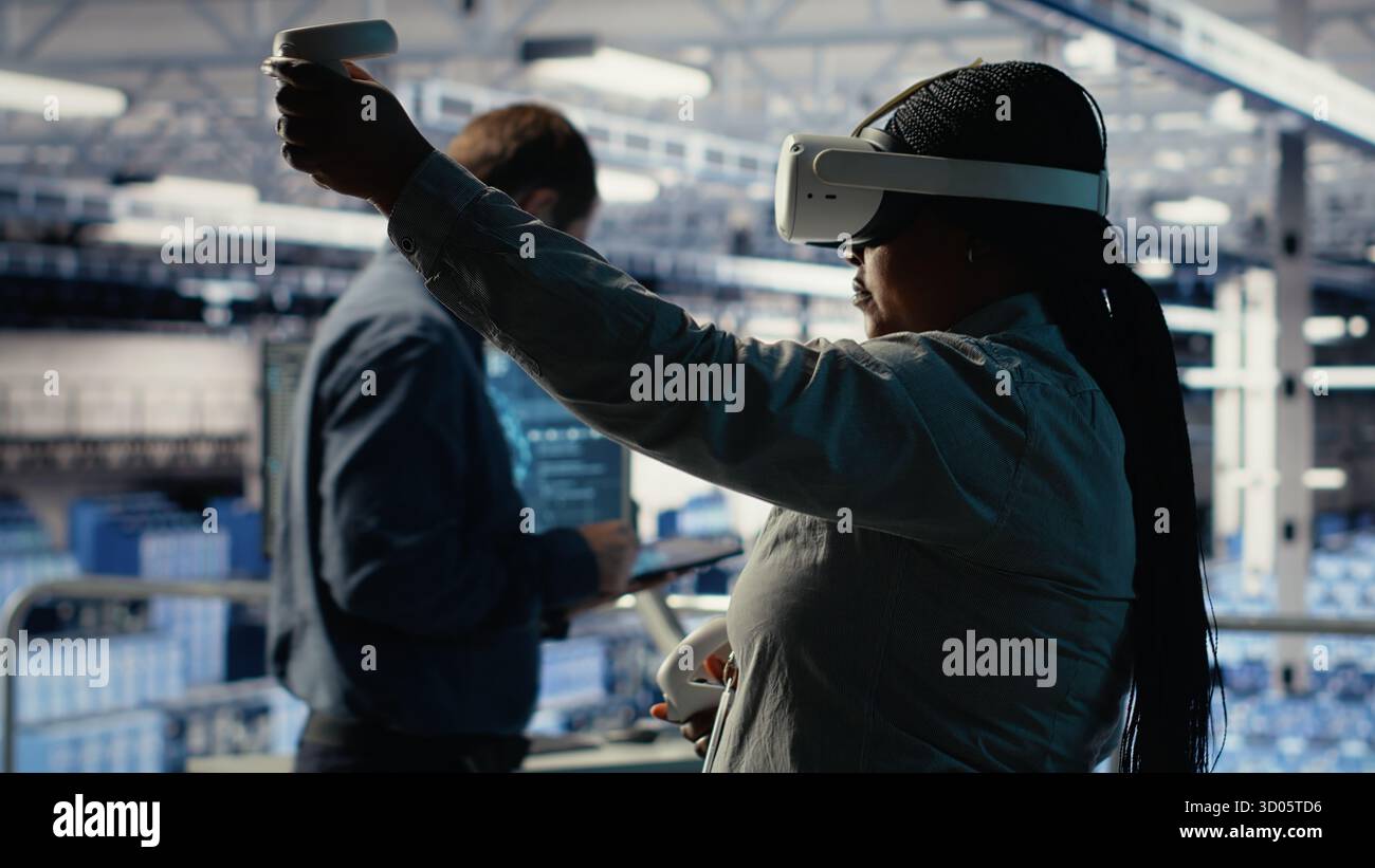 Software developer in server room wearing VR goggles optimizing deep learning systems handling tasks. African american woman in data center adjusts AI model parameters using virtual reality, camera B Stock Photo