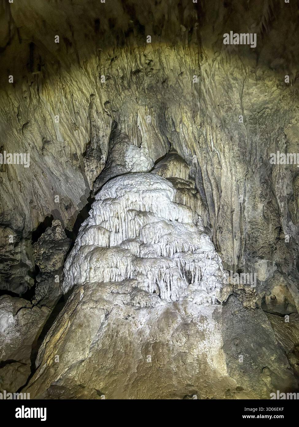 Impressive stalagmite formation inside the Ice Cave of Uvac Canyon, showcasing natural limestone shapes and cave textures. - Smartphone Captured Stock Image