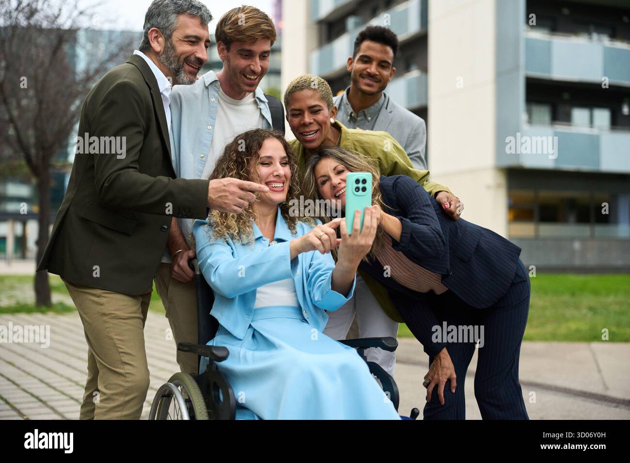 Diverse colleagues taking selfie together in urban setting Stock Photo