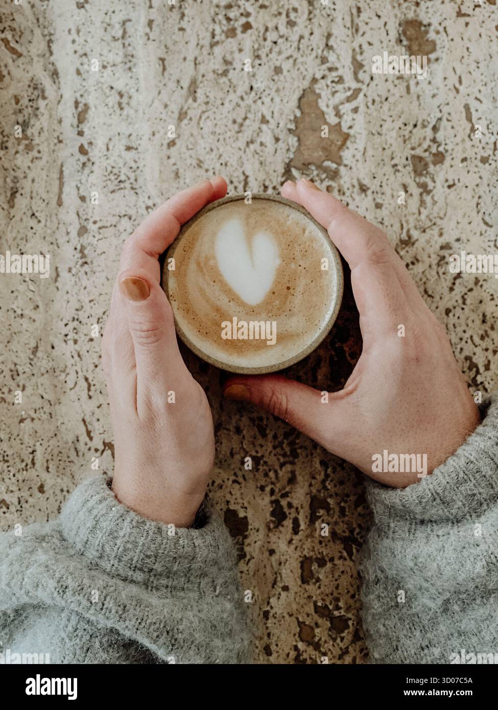 Cappucciono hand woman table Stock Photo