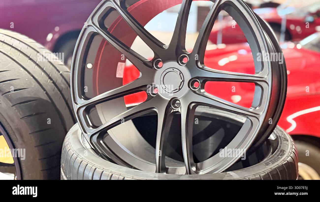 Silver Alloy Wheel Close Up, Modern Car Rim Design, Automotive Workshop Display, Luxury Vehicle Accessory, High Performance Metal Structure - Smartphone Captured Stock Image