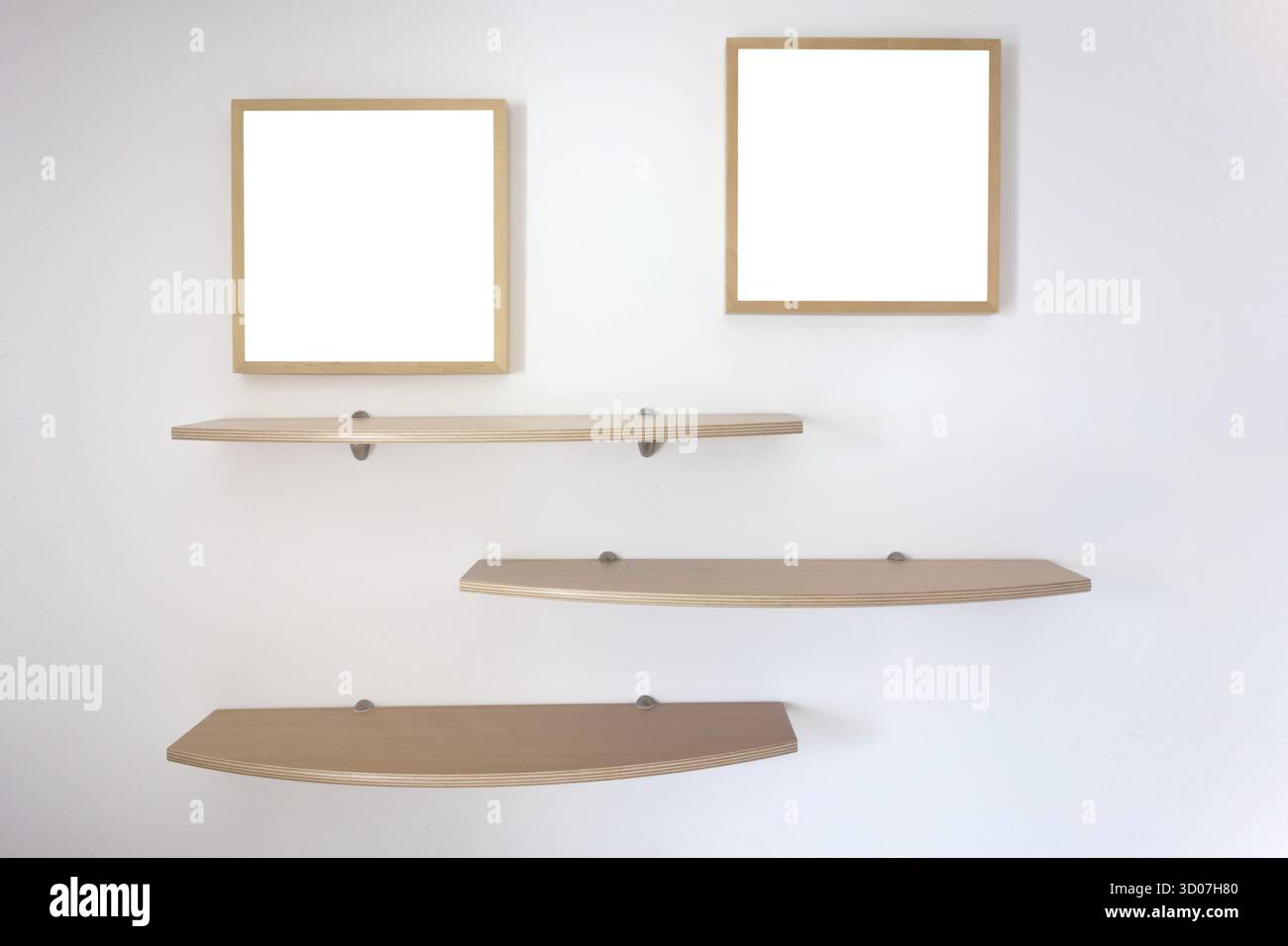 Shelves and photo frames on a wall Stock Photo