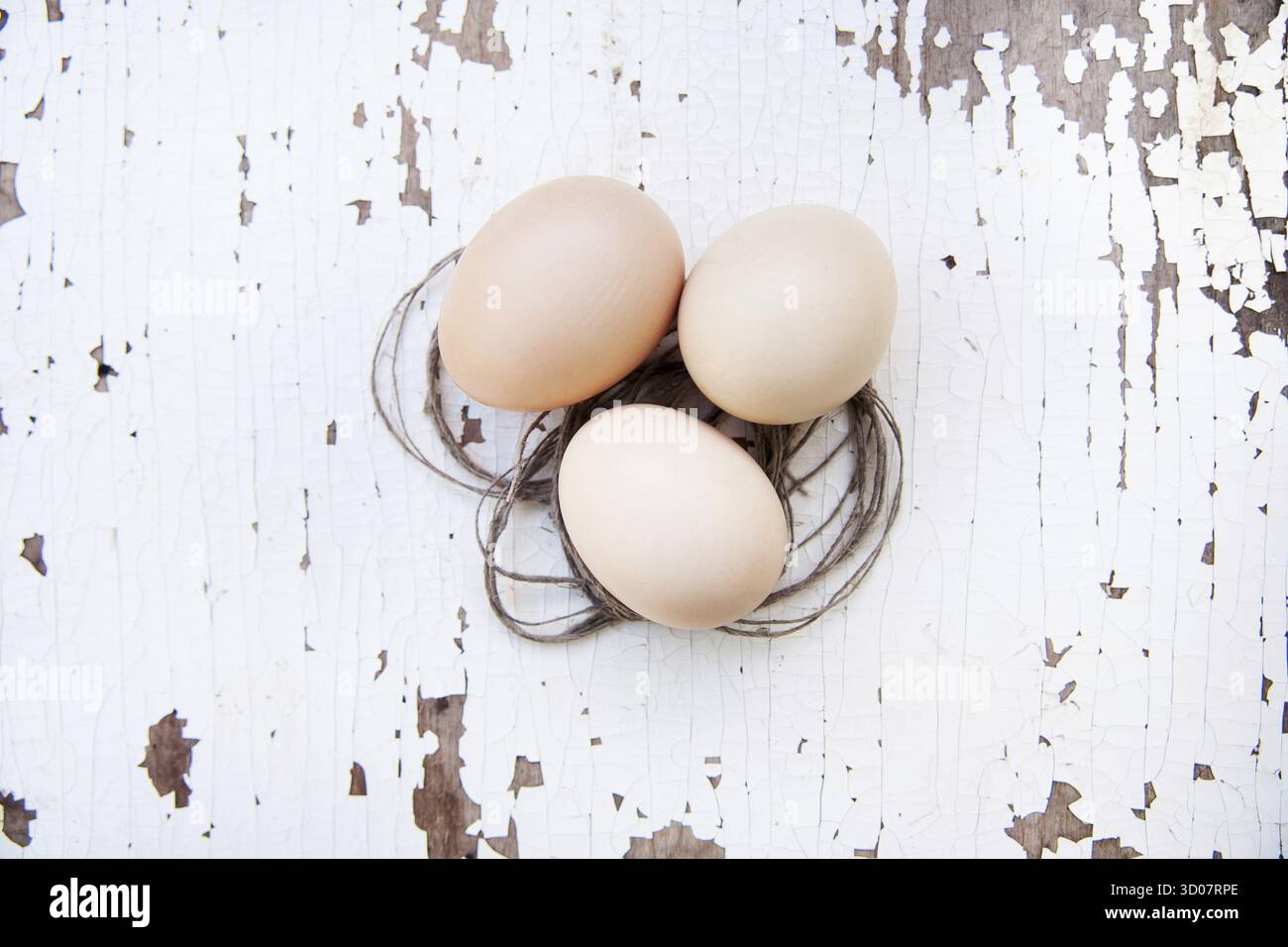 Eggs lie on an old white table Stock Photo