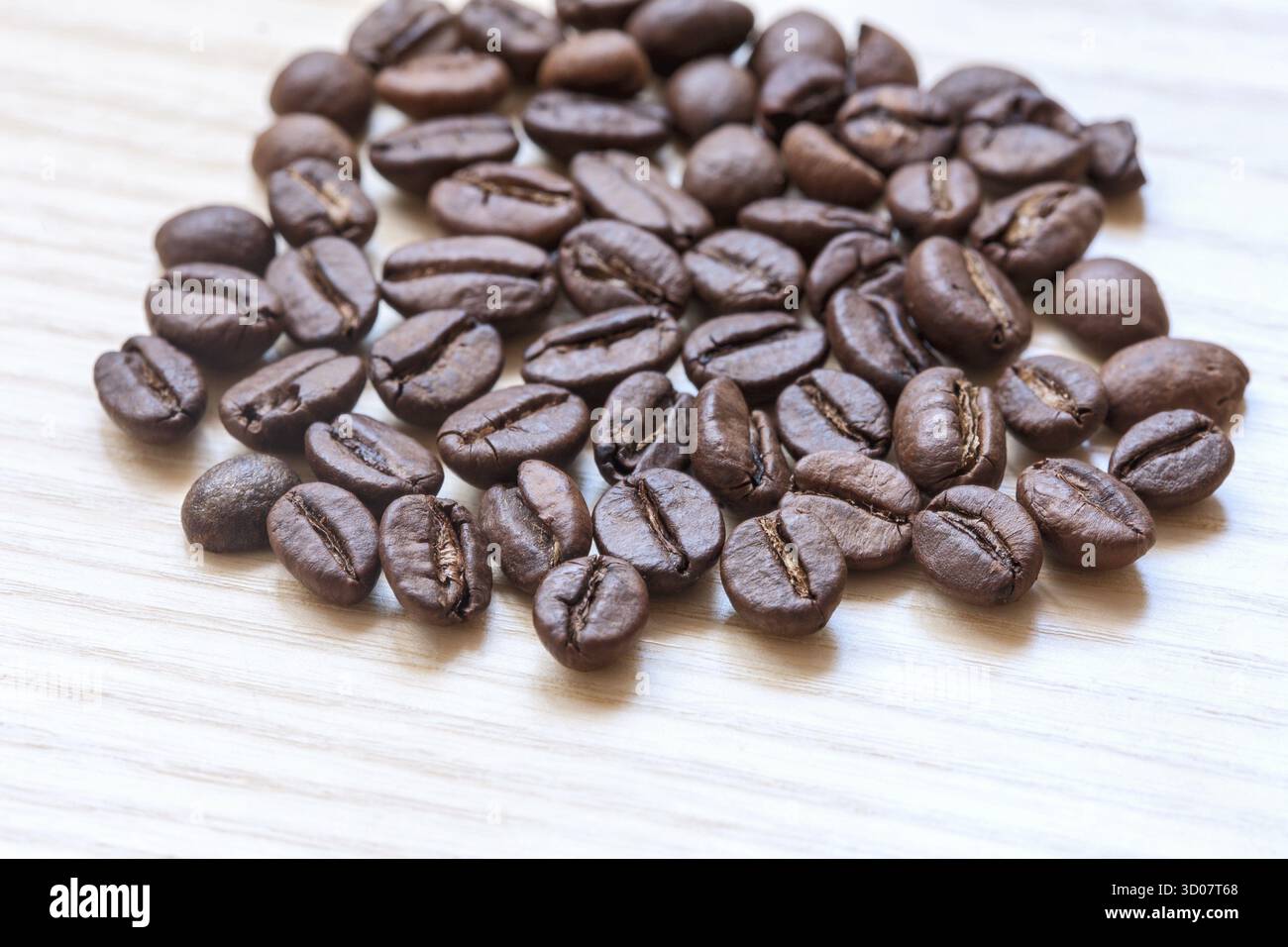 Coffee beans on white wooden background Stock Photo