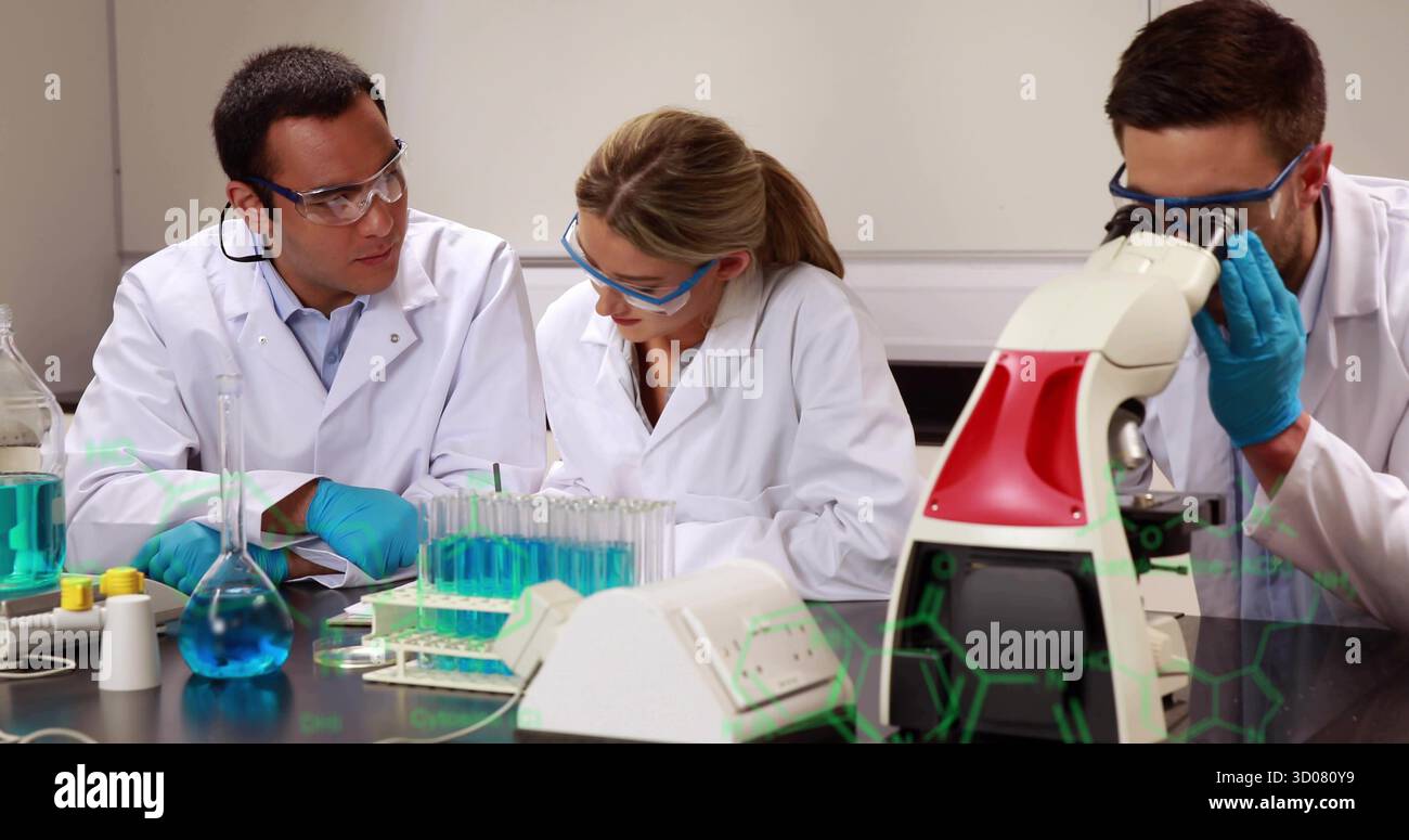 Examining samples scientists in coats and goggles using microscope in lab, with molecular graphics Stock Photo