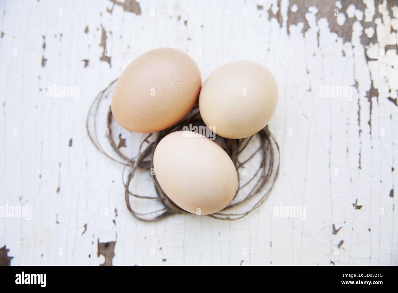 Eggs lie on an old white table Stock Photo