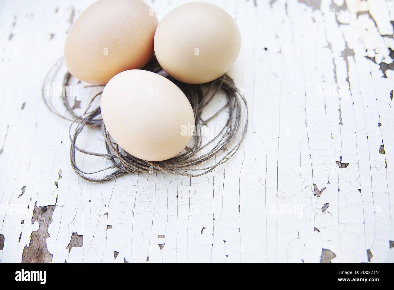 Eggs lie on an old white table Stock Photo