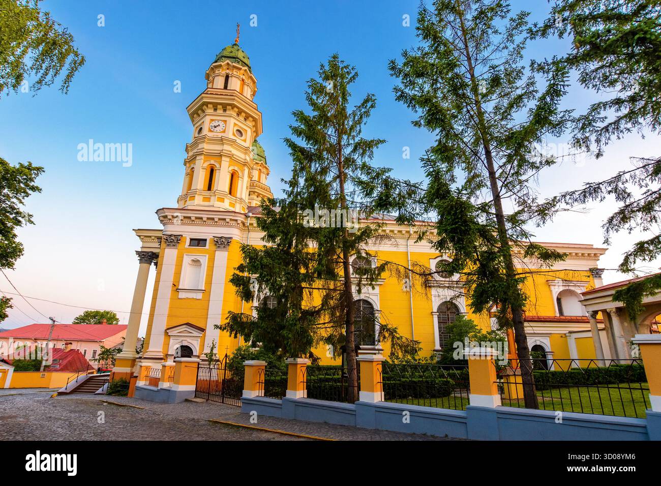 uzhhorod, ukraine - 04 jun 2017: holy cross cathedral at sunrise in summer. beautiful view of greek catholic church in center of old town. dome and co Stock Photo