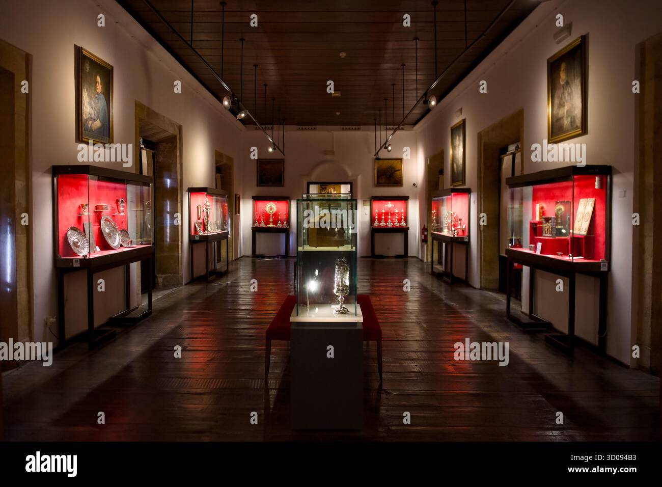 Museum exhibition hall with illuminated display cases showcasing ...