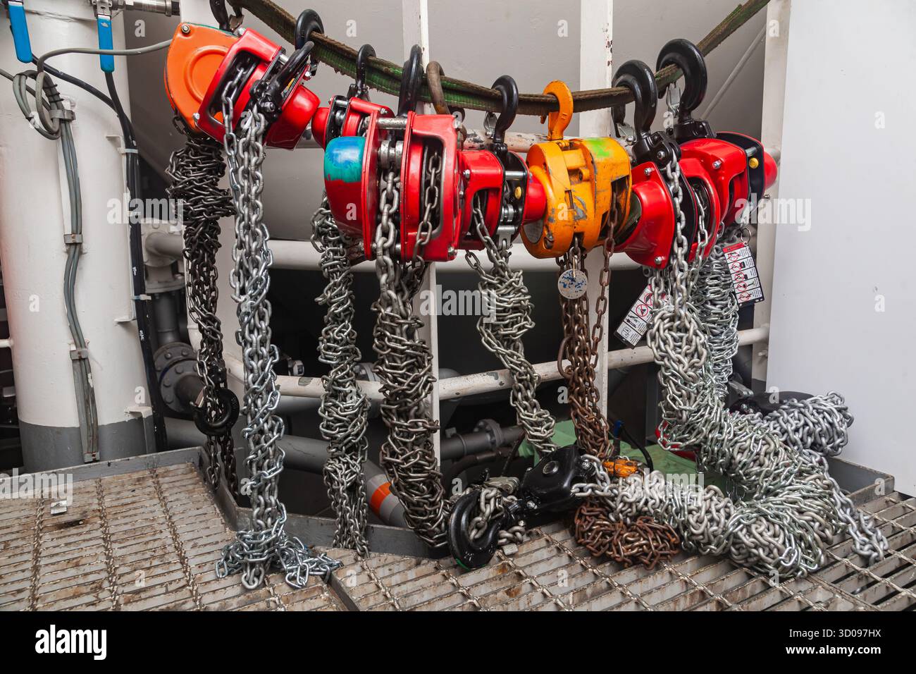 Chain hoists for lifting weights in a workshop close-up Stock Photo