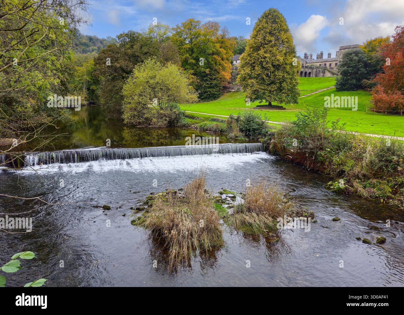 The weir on the River Manifold at Ilam Hall and gardens, Ilam, Staffordshire, England, UK - Smartphone Captured Stock Image