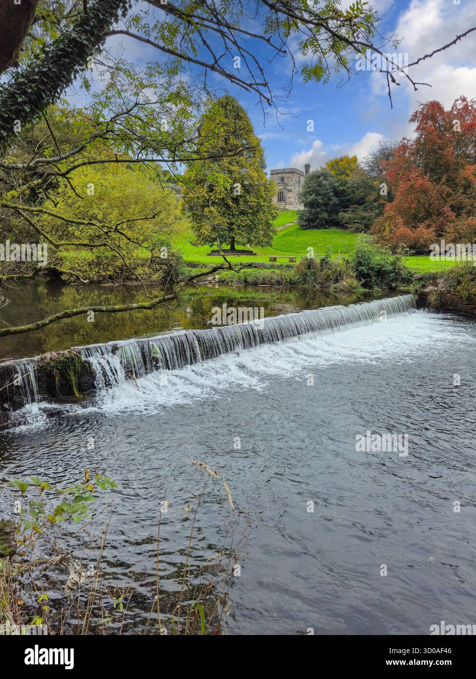The weir on the River Manifold at Ilam Hall and gardens, Ilam, Staffordshire, England, UK - Smartphone Captured Stock Image
