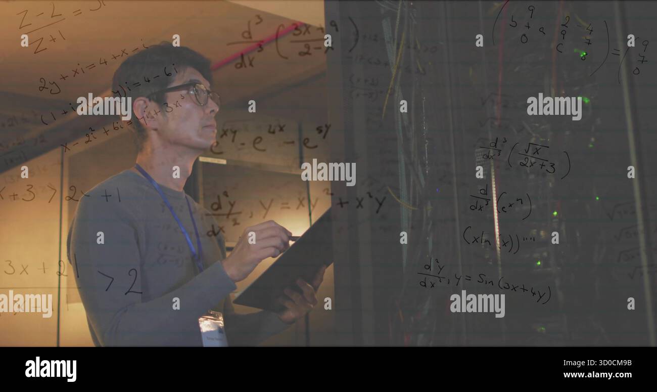 IT technician holding clipboard and inspecting server racks in data center, with LEDs, copy space Stock Photo