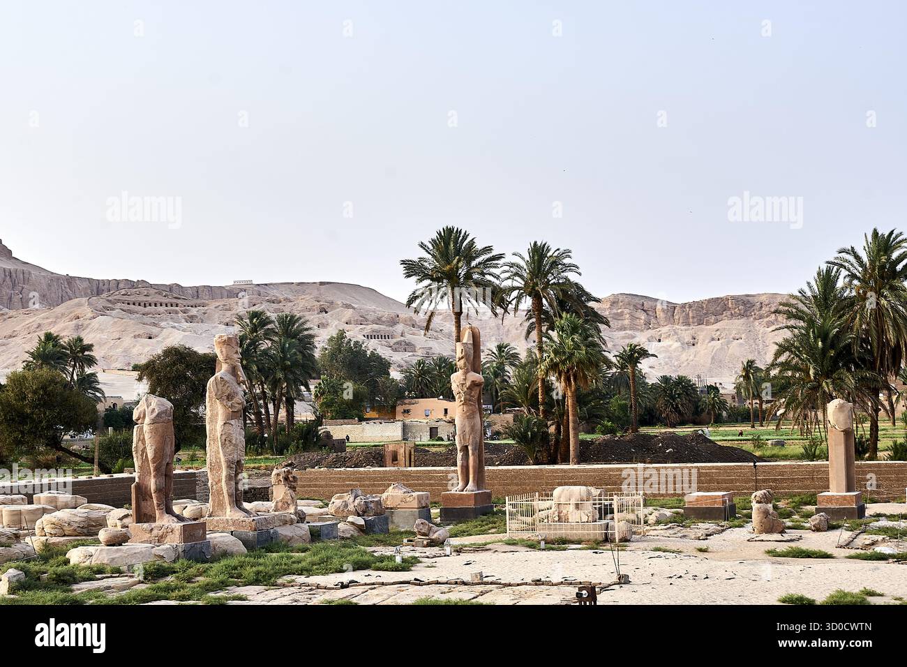 Statues in the ruins of the ancient temple of Thebes with its ...