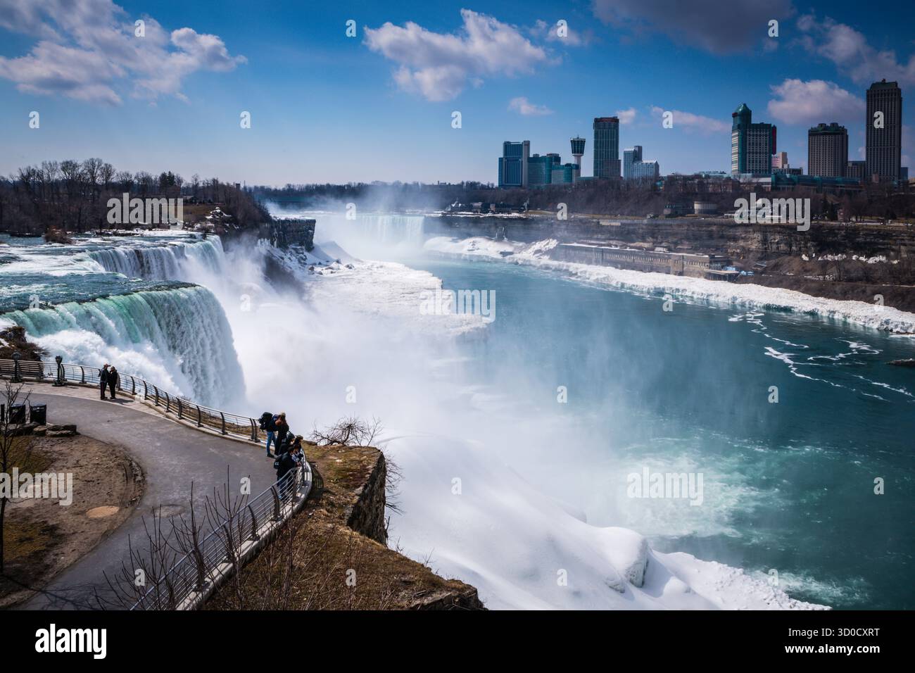 Niagara Fall, NY USA - March 19, 2019: Visitors admiring the magnificent view from the American Falls, on the American side of Niagara Falls. Stock Photo