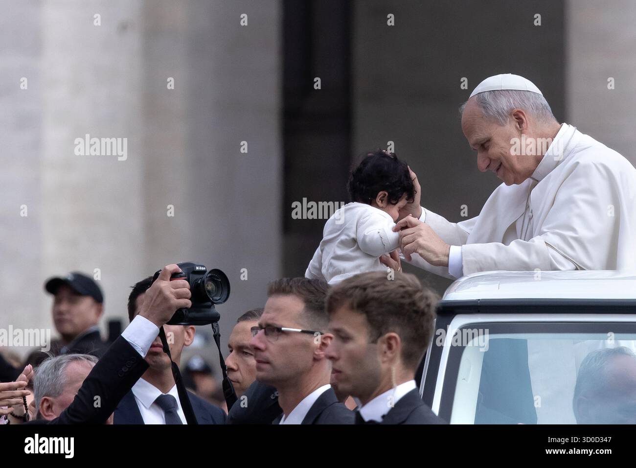 Vatican, Vatican. 22nd Oct, 2025. Pope Leo XIV greets a child as he arrives for his weekly general audience at St. Peter's square. Credit: SOPA Images Limited/Alamy Live News Stock Photo