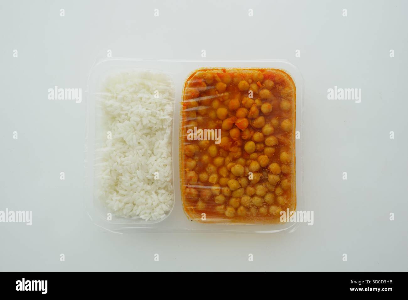 Chickpea dish with rice in a takeout container Stock Photo - Alamy
