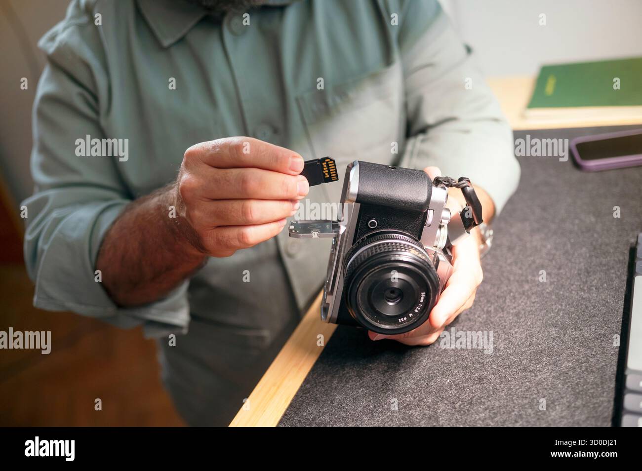 Man inserting memory card into camera. Stock Photo