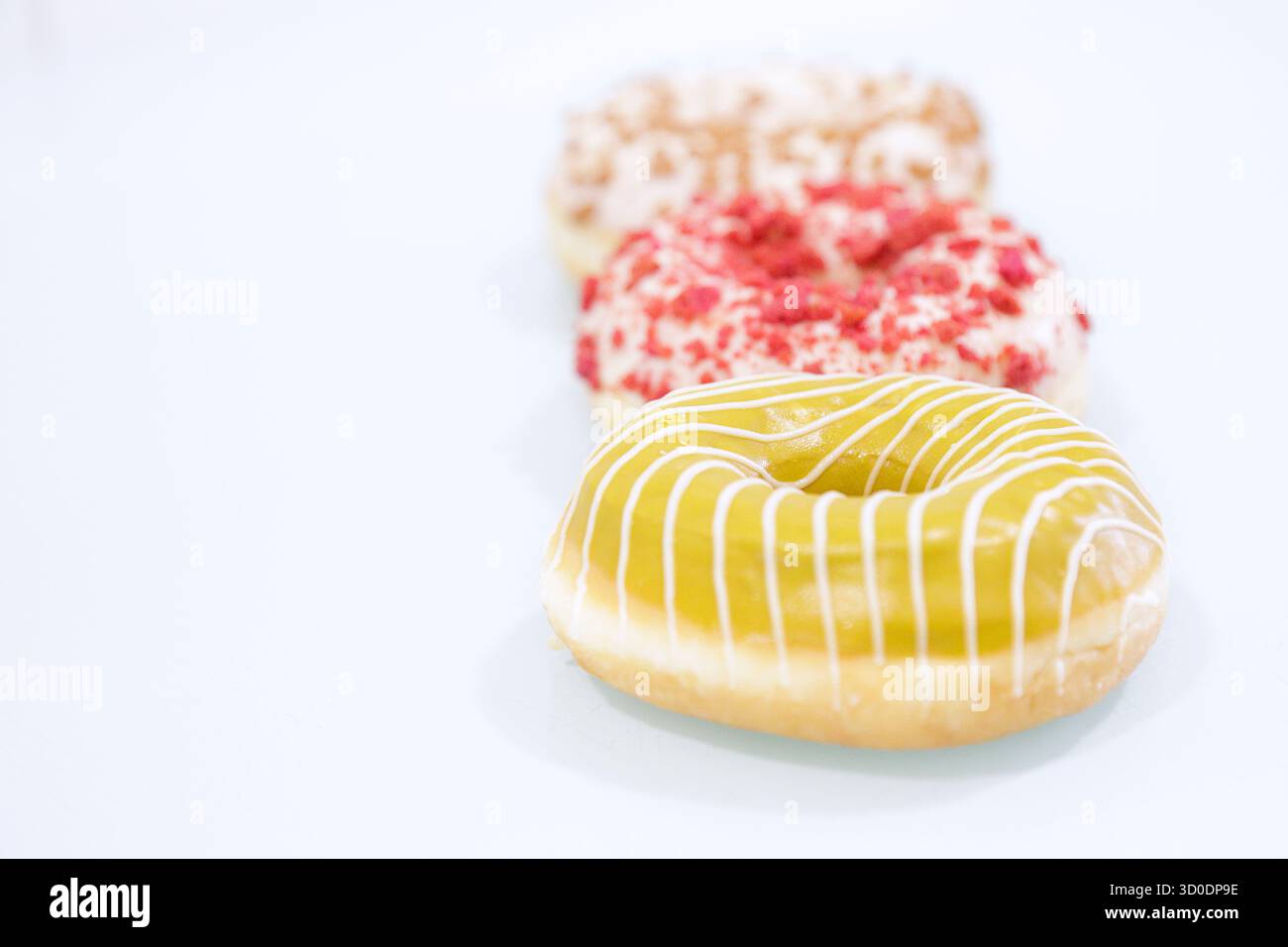 Delicious glazed donuts on white background. Stock Photo