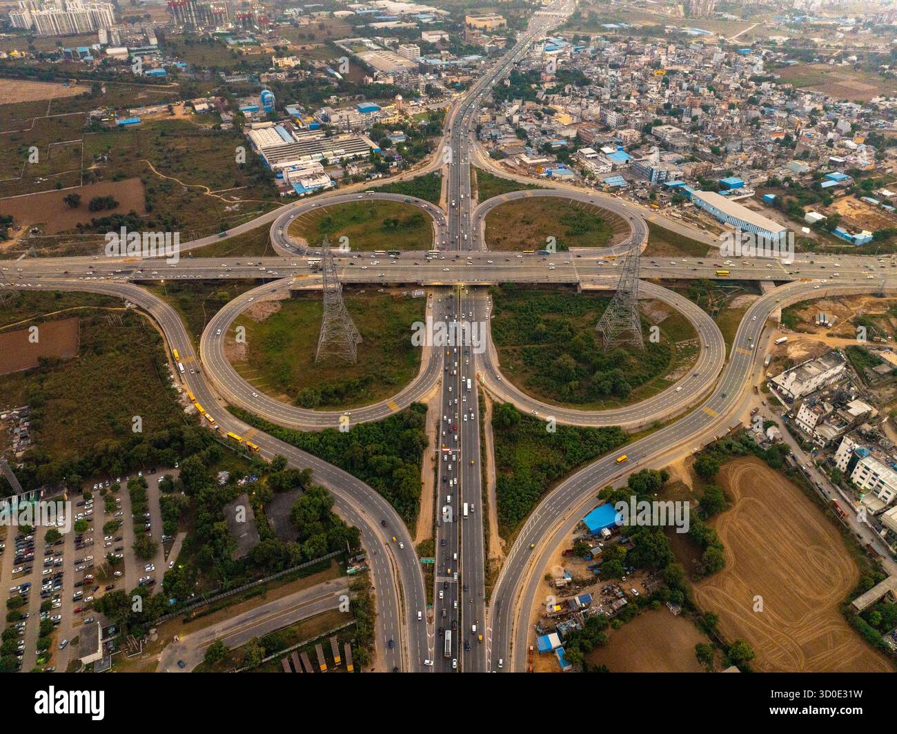 Aerial view of a complex road interchange with cloverleaf ramps amidst ...