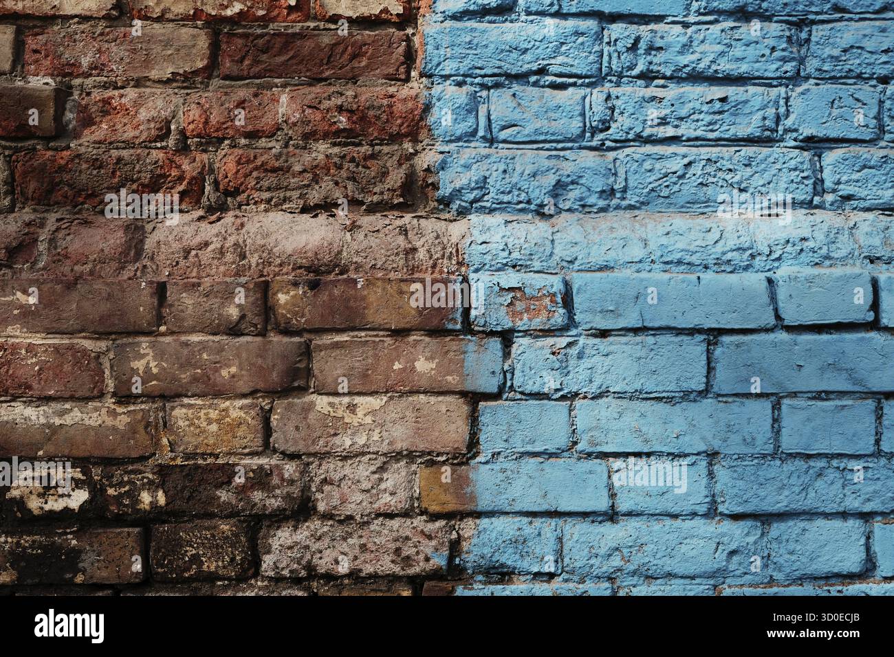 Weathered Half Painted In Blue Brick Wall Stock Photo
