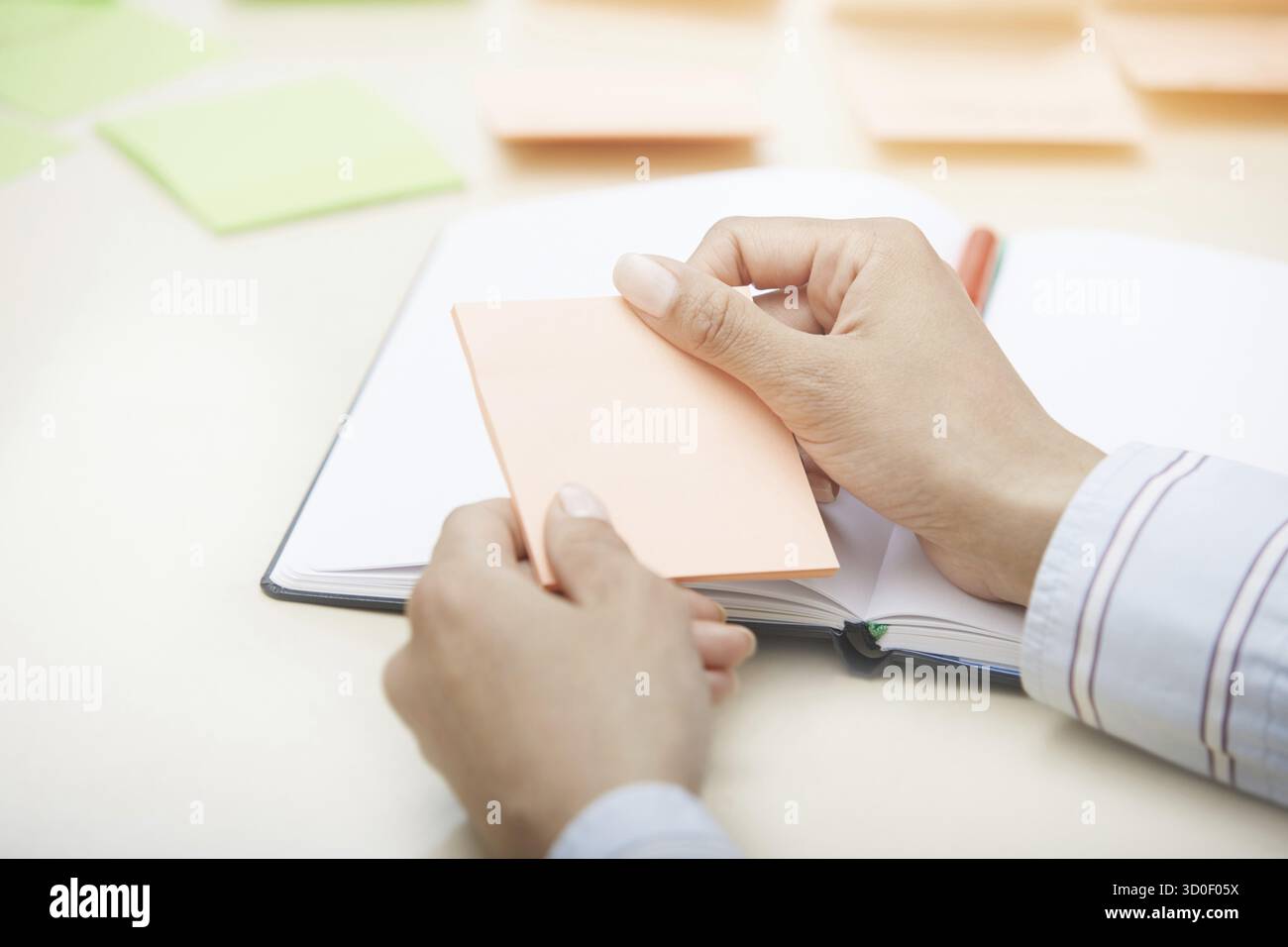 Hands holding sticky note with empty space Stock Photo