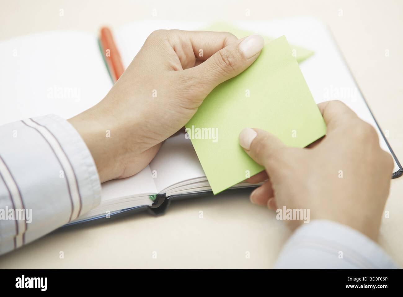 Hands holding sticky note with empty space Stock Photo