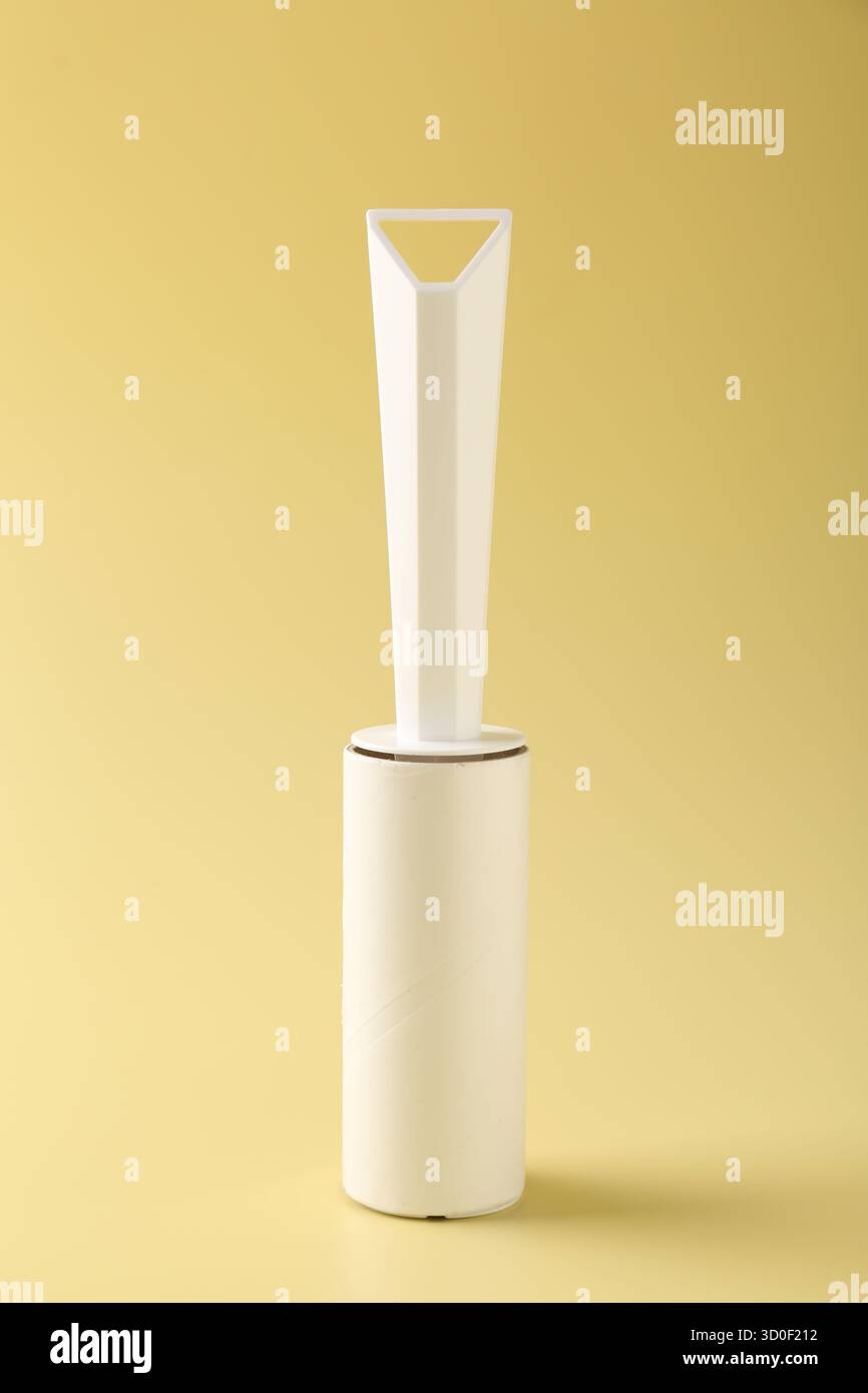 One lint roller on yellow background, closeup Stock Photo