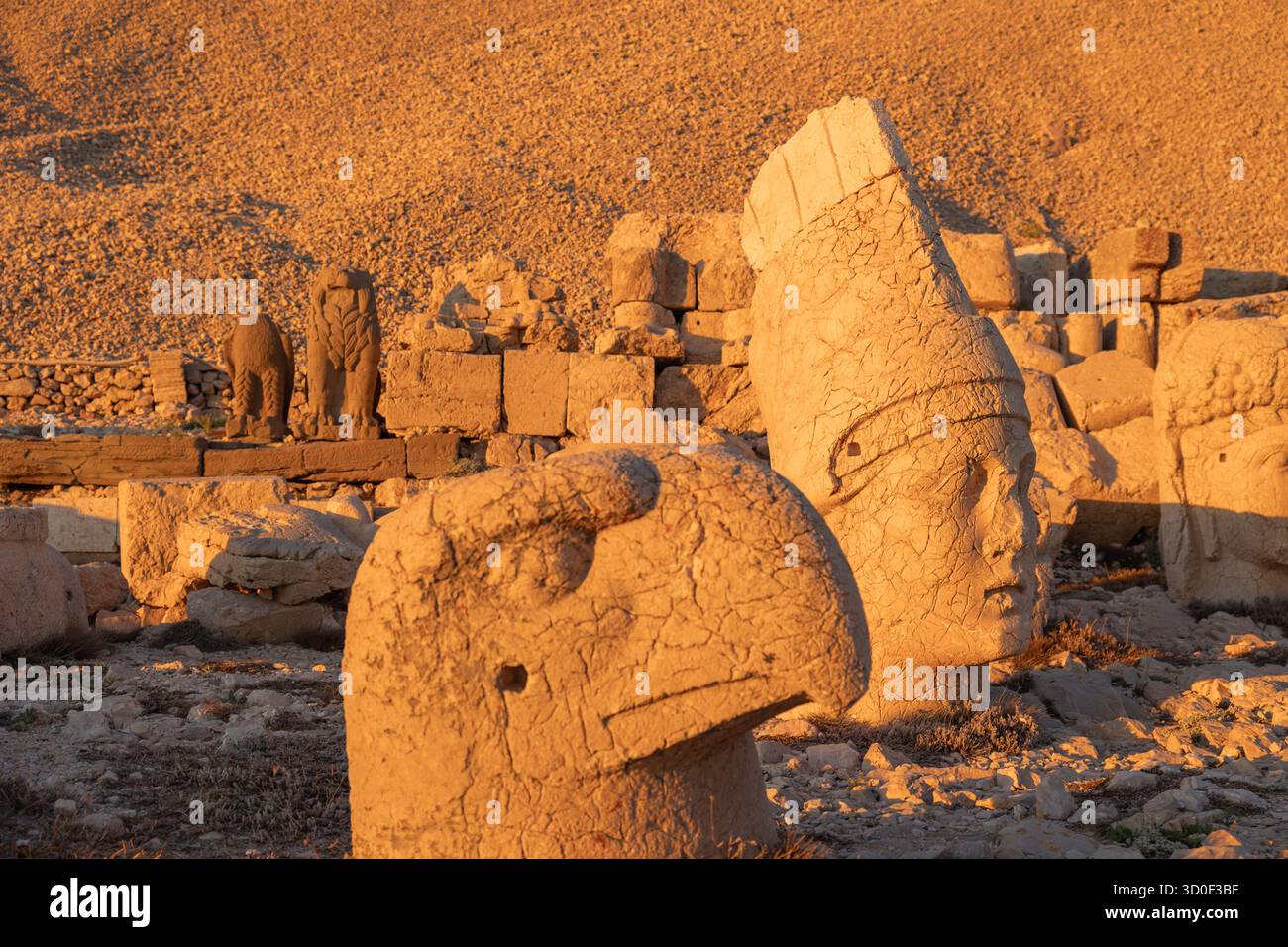 Persian eagle and Apollo or Hermes Head statues in Mount Nemrut at sunset. Stock Photo