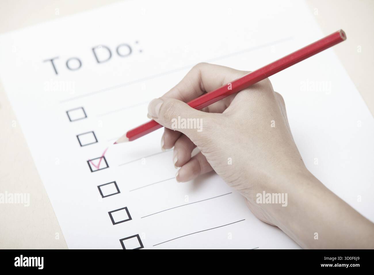 Human hand writing on a checklist document Stock Photo