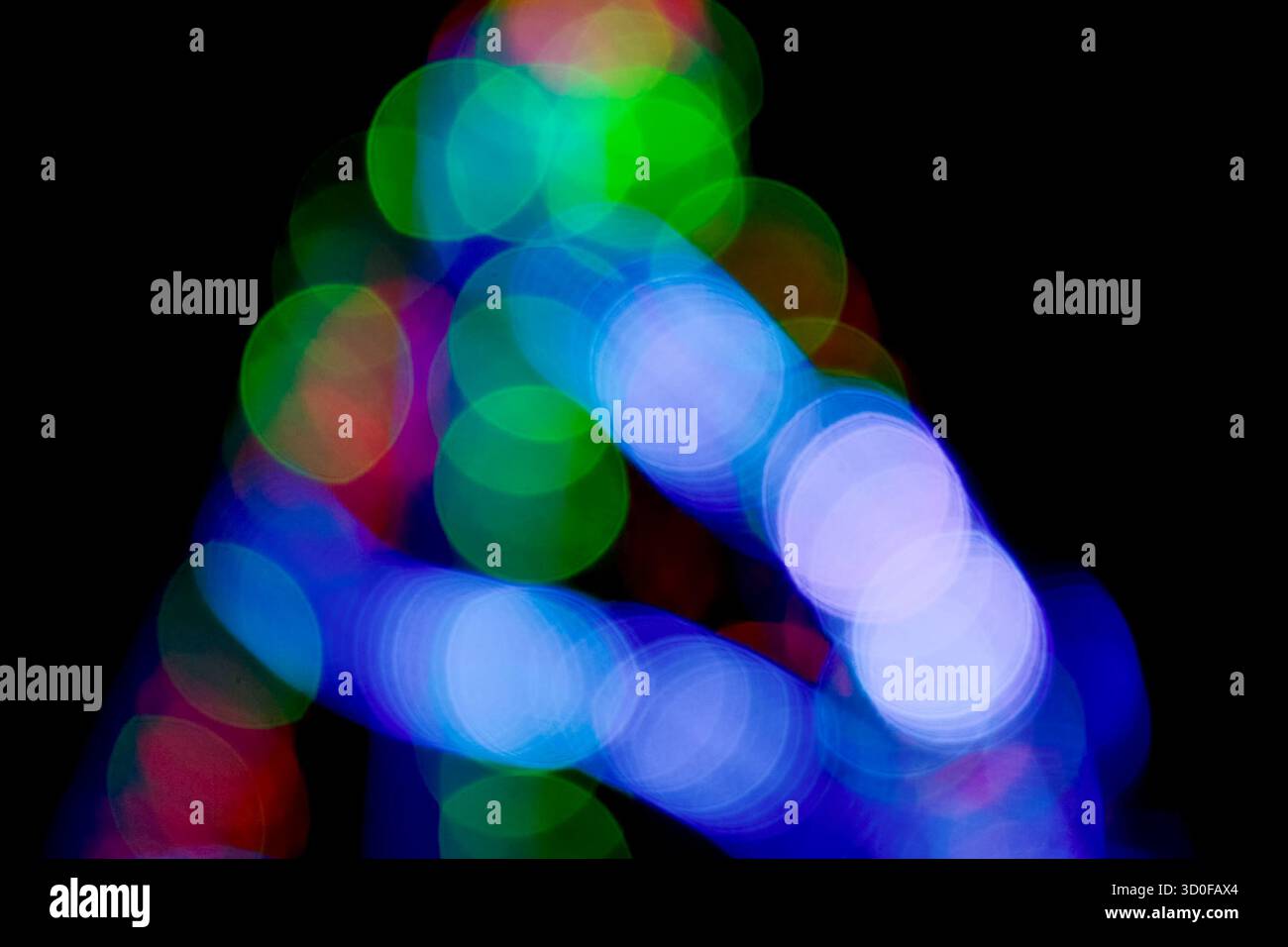 new year lights bokeh background. defocused abstract christmas decorations. blurred garland for festive mood. technological winter holidays. shimmerin Stock Photo