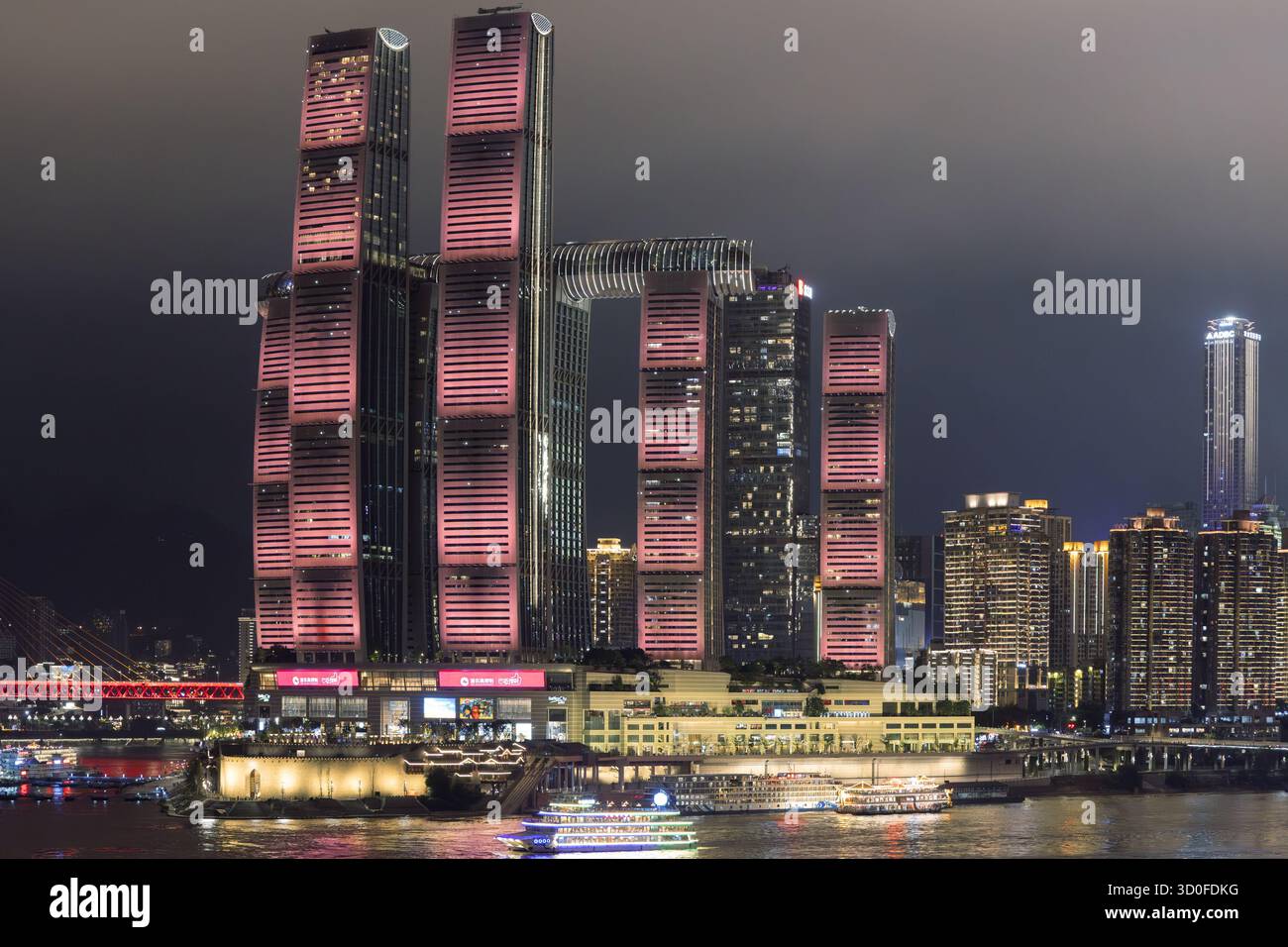 Aerial view of the Raffles City Chongqing complex illuminated with ...
