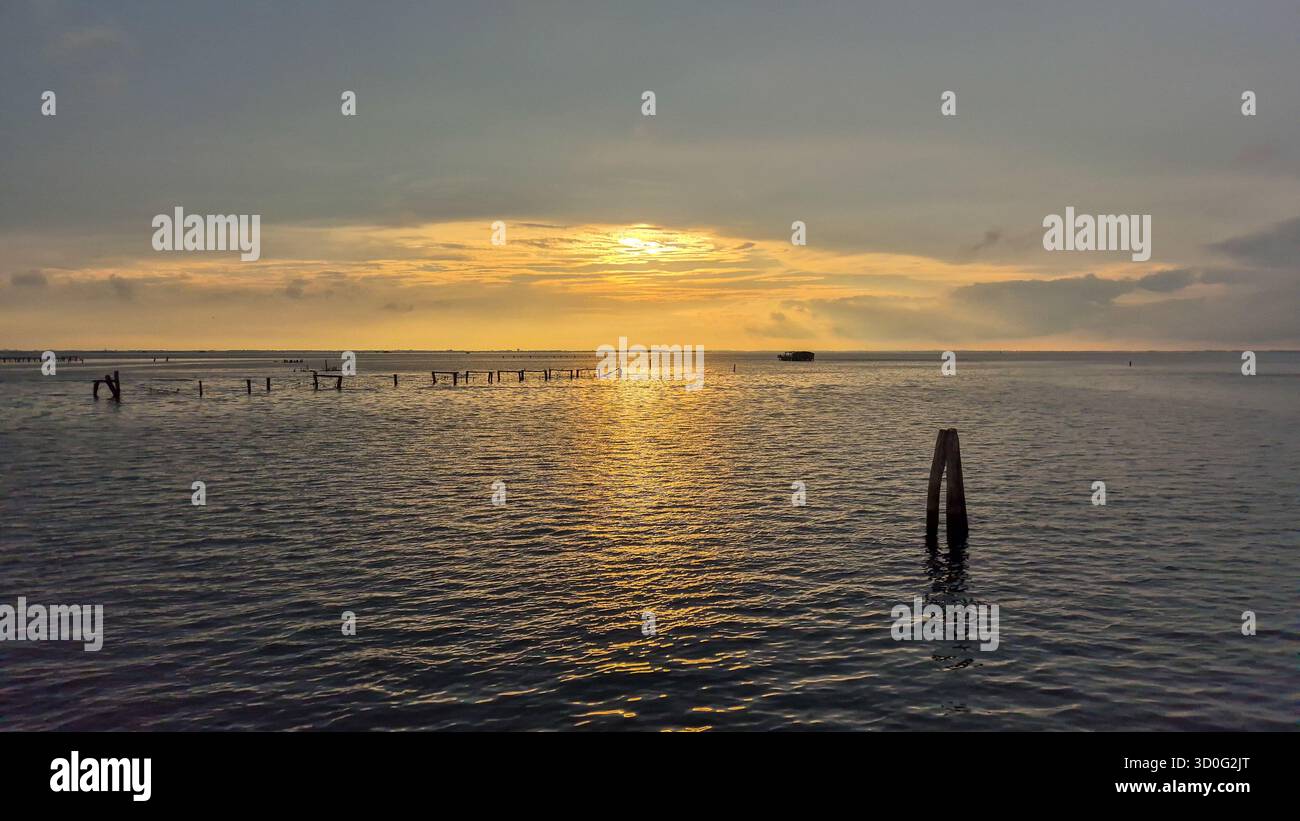 Adriatic Sea sunset landscape near Venice, Italy, golden evening light over calm coastal water. - Smartphone Captured Stock Image