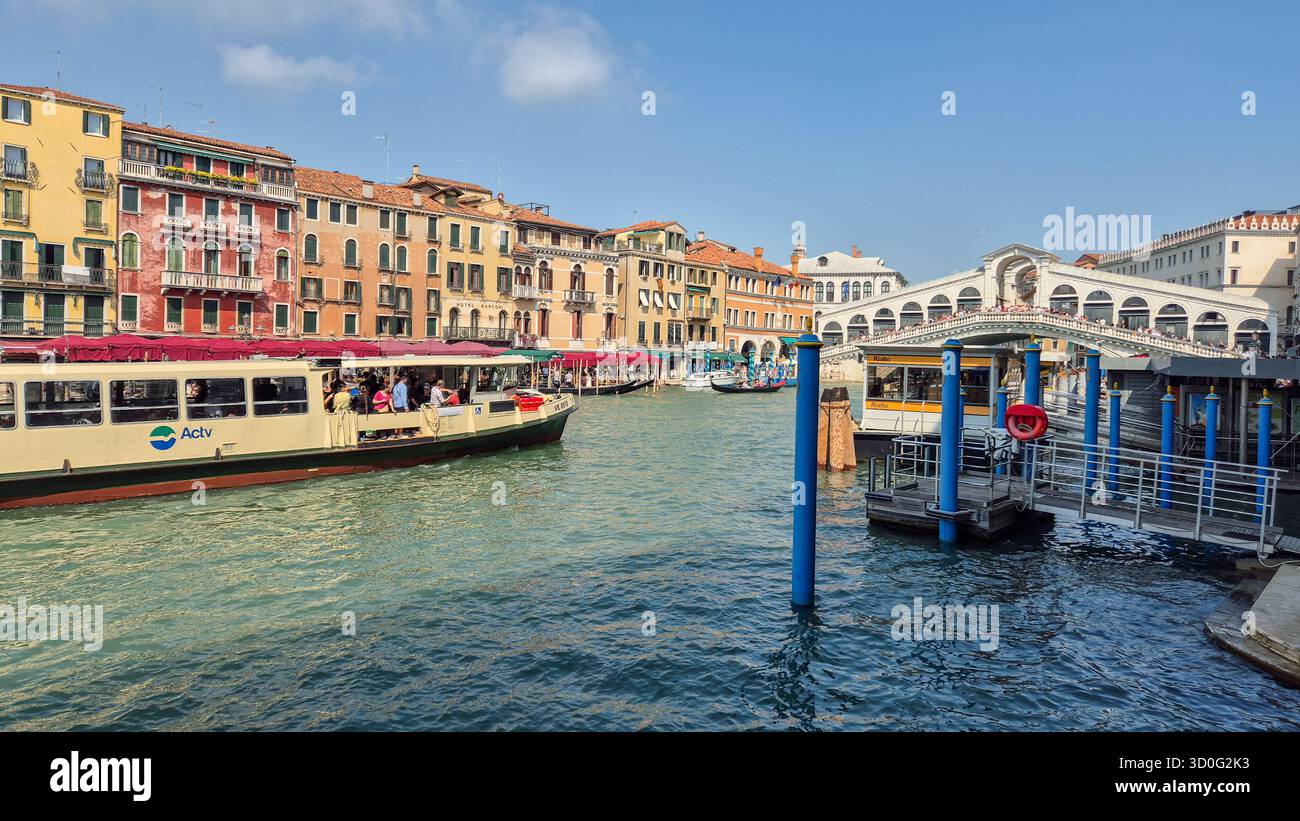 View of Grand Canal and Rialto Bridge in Venice, Italy with local boats and water transport. - Smartphone Captured Stock Image