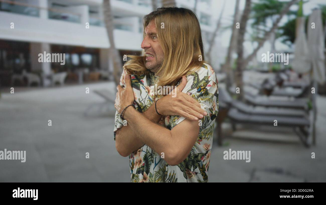 Blond man shivering hugging arms hi-res stock photography and images ...