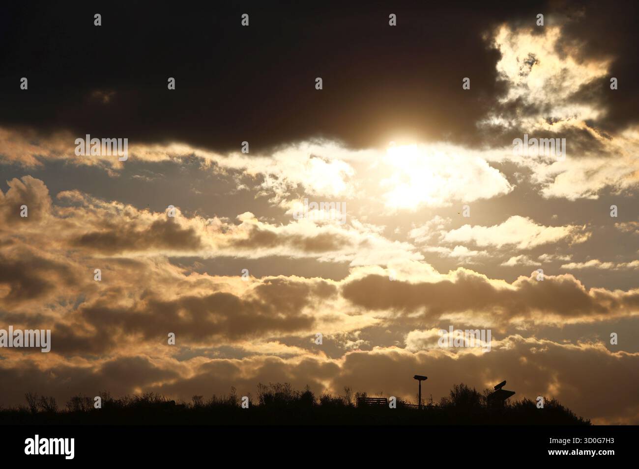 Sunset Through Dramatic Clouds Stock Photo - Alamy