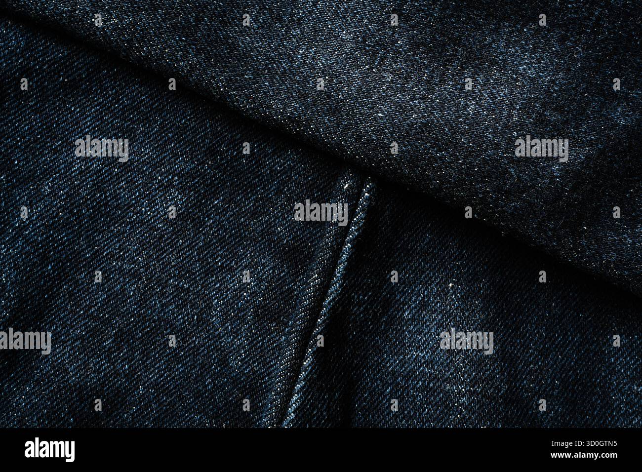 Dark blue jeans with diagonal seam lines texture Stock Photo