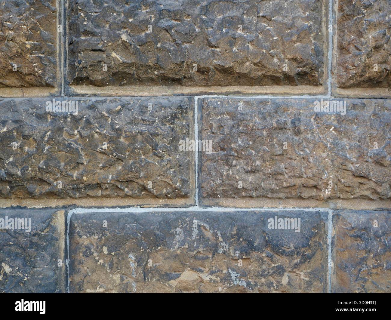 Historic rusticated stone wall with irregular, rough blocks. Close-up. Copyspace. Stock Photo
