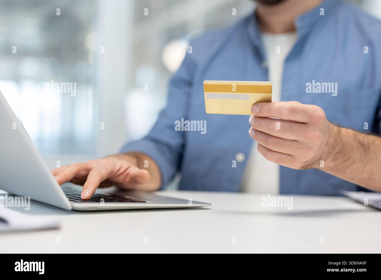 Visual Reference: Man Holding A Credit Card While Typing On A Laptop