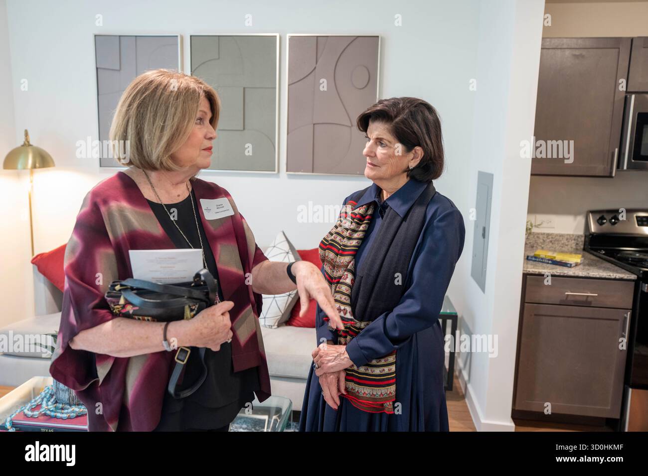 Austin Texas USA, October 22 2025: LUCI BAINES JOHNSON (right), daughter of President Lyndon Baines Johnson, listens to building developer Diana McIver as they tour an apartment during the grand re-opening of the Rebekah Baines Johnson senior housing complex in east Austin. The 224-bed concrete structure, completed at the behest of President Johnson just before he left office in 1968, underwent a five-year major renovation by the Austin Housing Finance Corp. McIver's firm oversaw the redevelopment. ©Bob Daemmrich Stock Photo