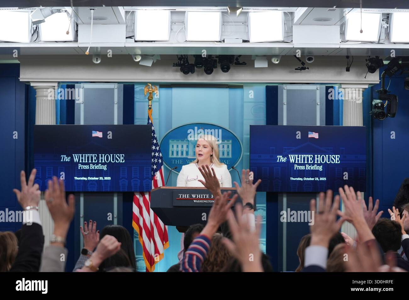 Reporters raise their hands to as a question as White House press ...