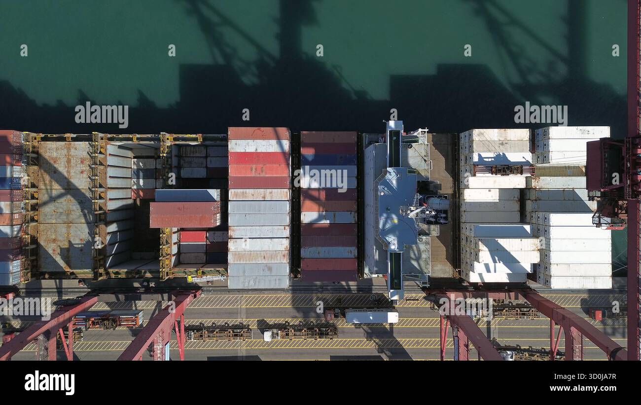 Dock Container Cargo containers stacked during unloading at shipping dock Stock Photo ...