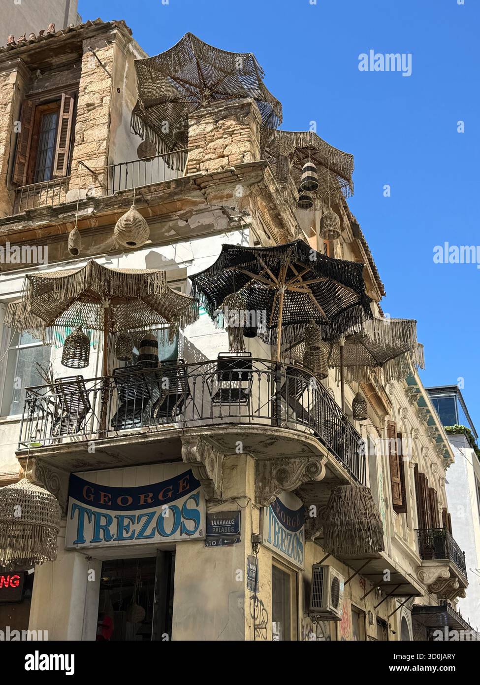 Umbrellas provide shade on balconies and terraces in Athens, Greece Stock Photo