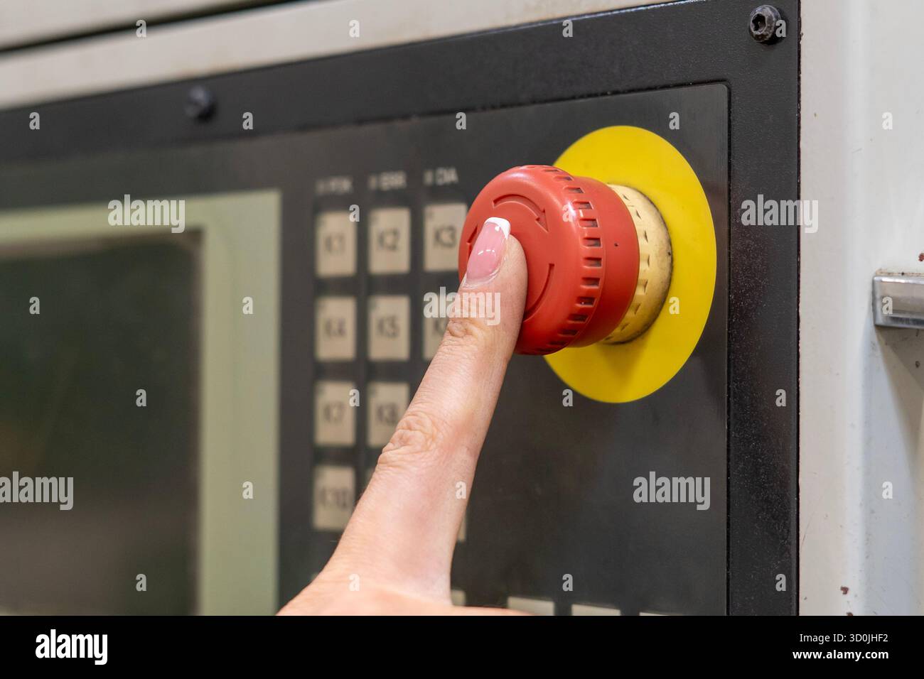 Red emergency stop button on an industrial control panel Stock Photo