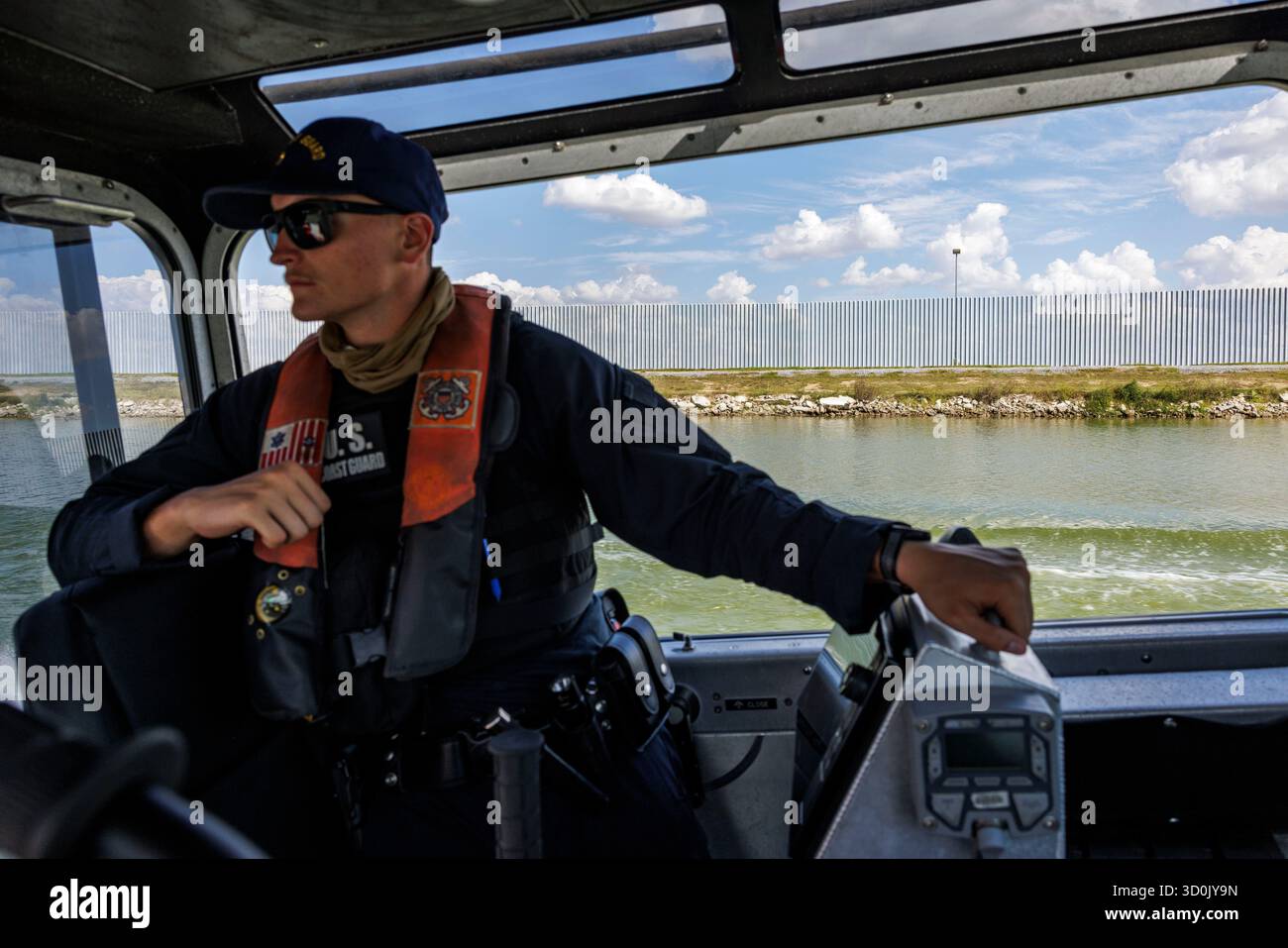 Uscg Rio Grande A U.S. Coast Guard member stands on a patrol boat on the Rio Grande ...