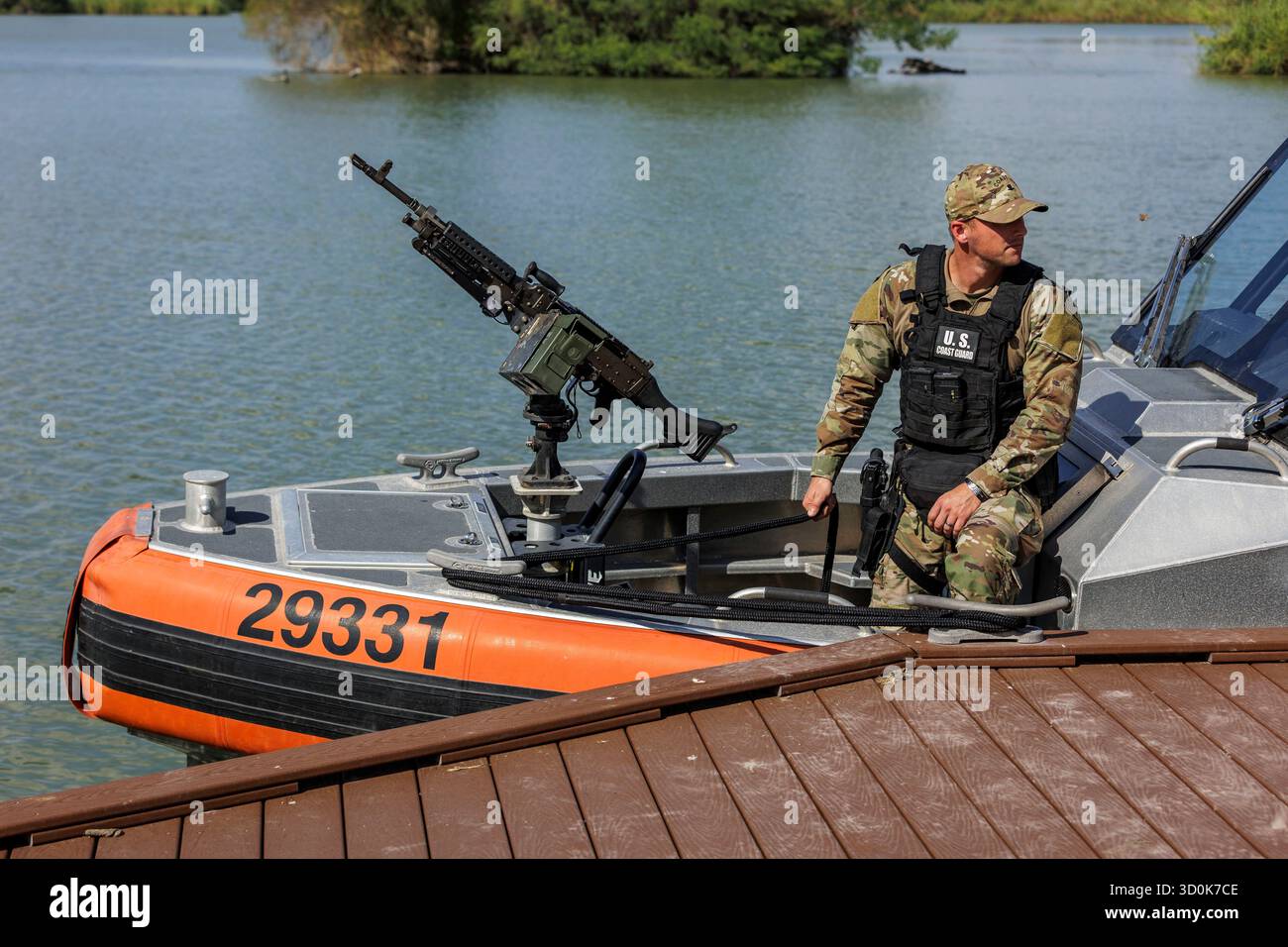 Uscg Rio Grande A U.S. Coast Guard member prepares to patrol the Rio Grande River on ...