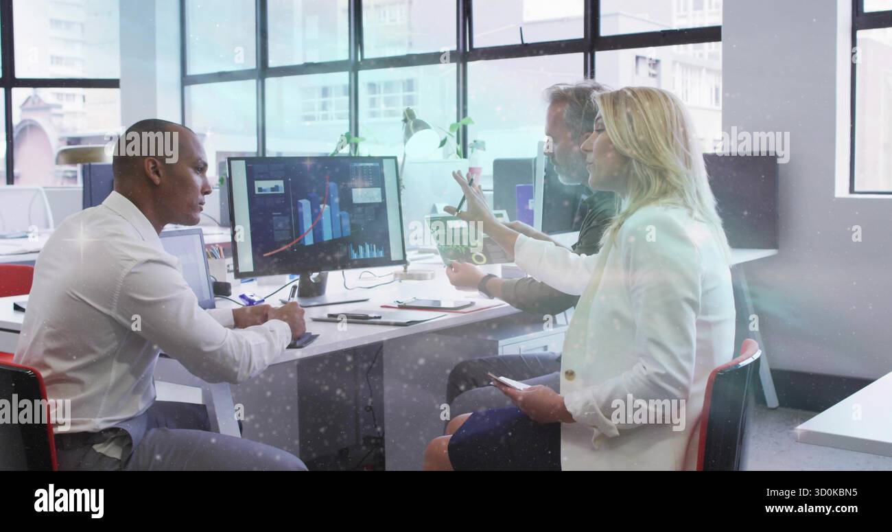 Collaborating three business professionals analyzing charts in office with monitor tablet documents Stock Photo