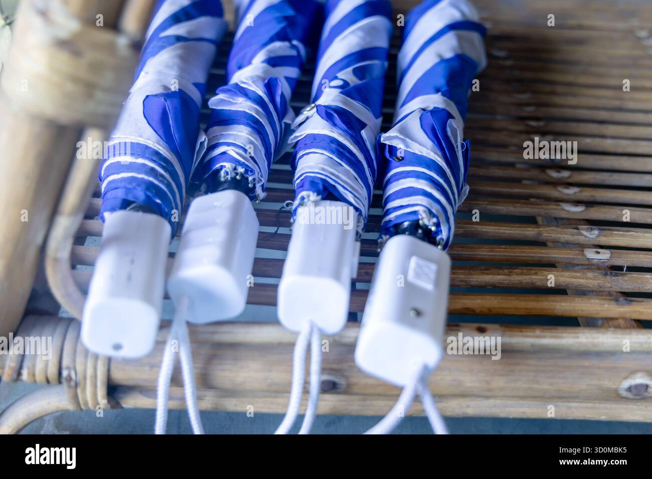 close-up of collapsed umbrellas on a bamboo surface * Stock Photo